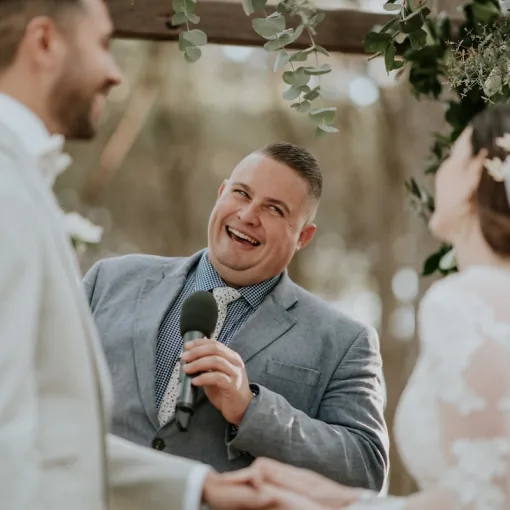 Josh Withers smiling as he conducts a wedding ceremony
